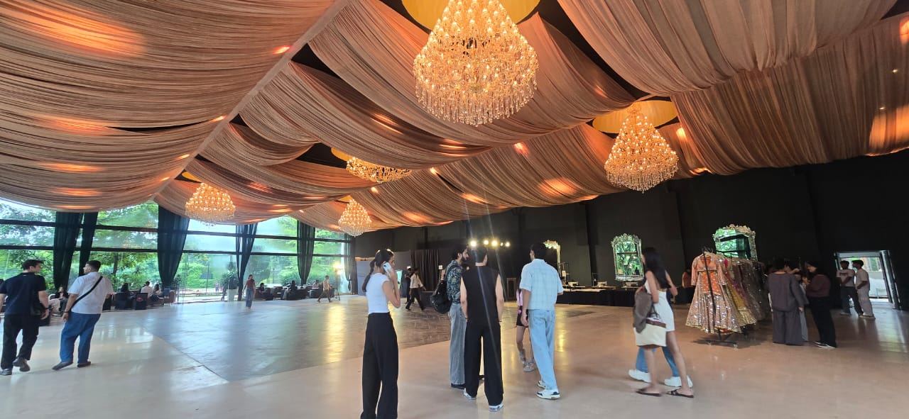 Event pavilion styled with draped fabric ceilings and crystal chandeliers